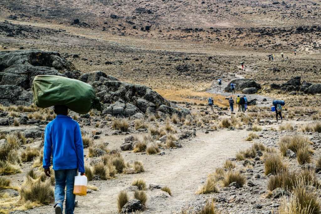 man carrying green sack