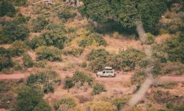 a van is parked in the middle of a dirt road
